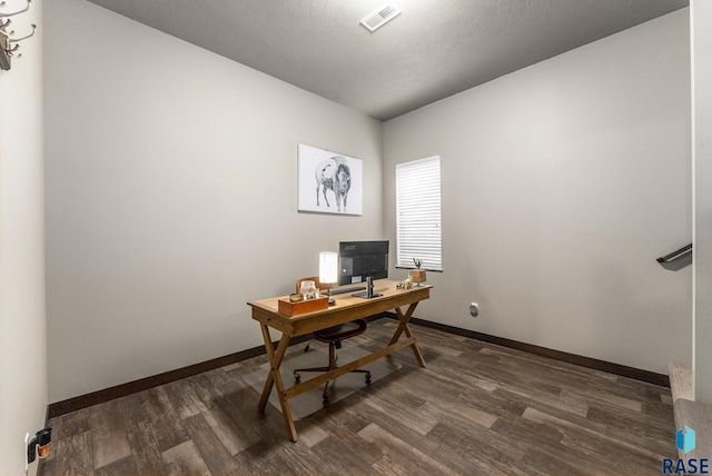 office space with dark hardwood / wood-style floors and a textured ceiling