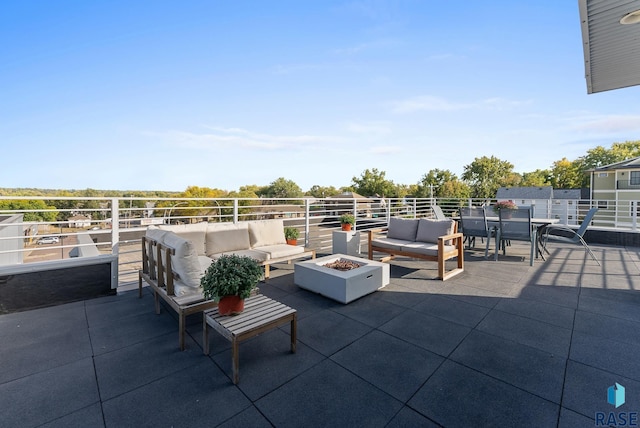 view of patio / terrace with an outdoor living space with a fire pit