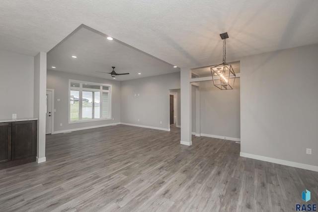 unfurnished living room featuring hardwood / wood-style floors, a textured ceiling, and ceiling fan