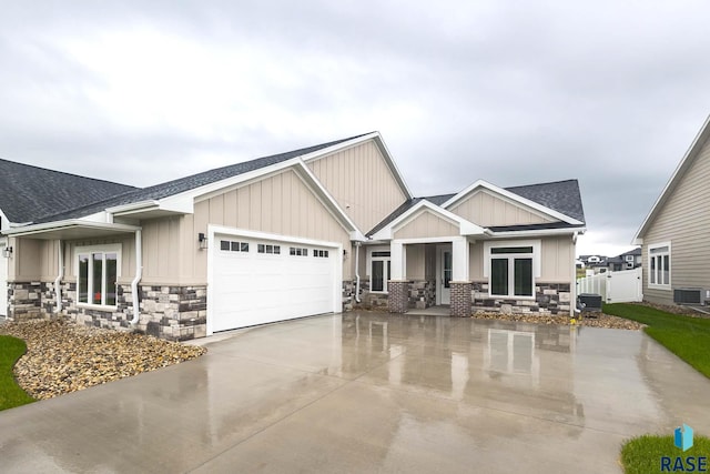 craftsman-style house with a garage and central AC