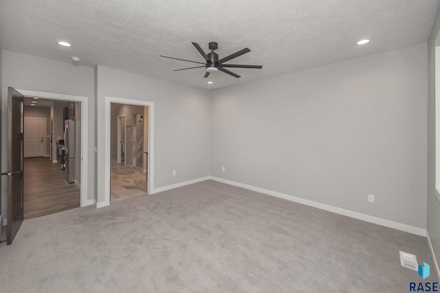 unfurnished room featuring carpet, a textured ceiling, and ceiling fan