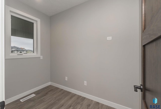 spare room with dark hardwood / wood-style floors