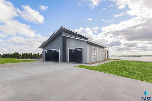 garage featuring a water view and a yard