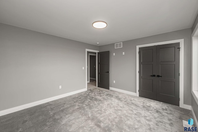 unfurnished bedroom featuring a closet and carpet