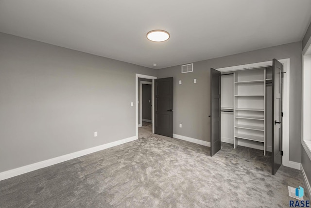 unfurnished bedroom featuring carpet floors and a closet