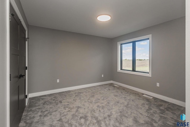 unfurnished bedroom with dark carpet