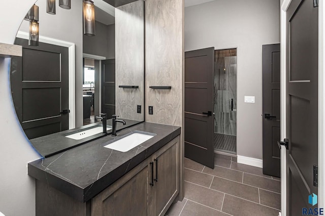 bathroom featuring tile patterned flooring, vanity, and an enclosed shower