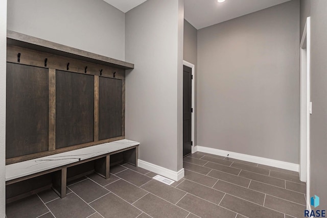 mudroom featuring dark tile patterned flooring