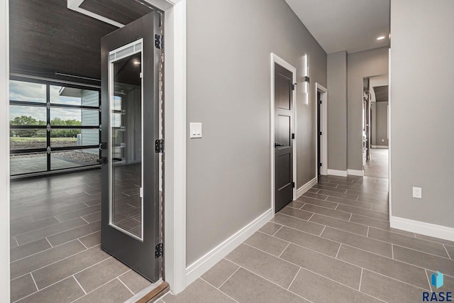 hallway with tile patterned flooring