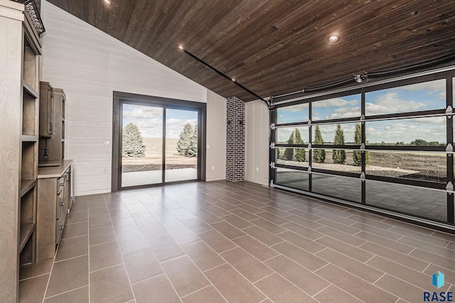 unfurnished living room with dark tile patterned floors, lofted ceiling, and wood ceiling