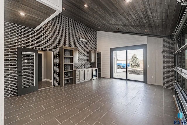 unfurnished living room with brick wall, high vaulted ceiling, and wood ceiling