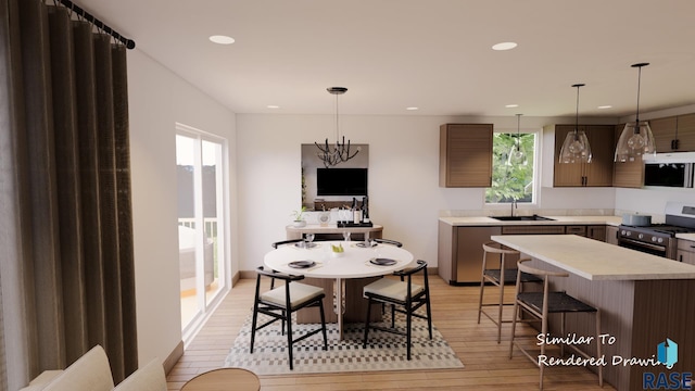 dining space featuring light wood finished floors and recessed lighting