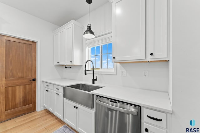 kitchen featuring sink, white cabinetry, dishwasher, pendant lighting, and light hardwood / wood-style floors