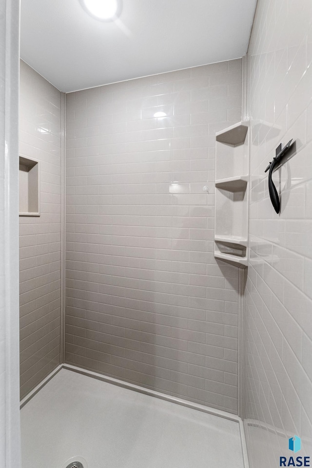 bathroom with tiled shower