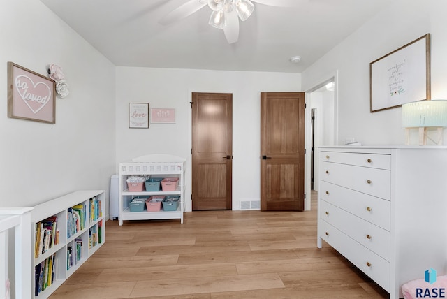 playroom featuring ceiling fan and light hardwood / wood-style floors