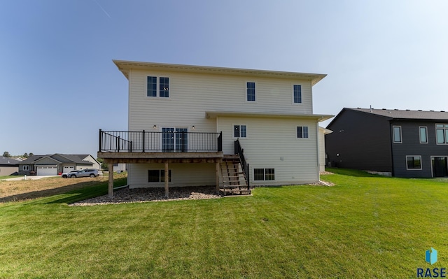 rear view of property with a wooden deck and a yard