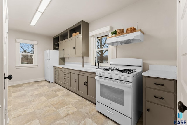 kitchen featuring sink, gray cabinetry, and white appliances