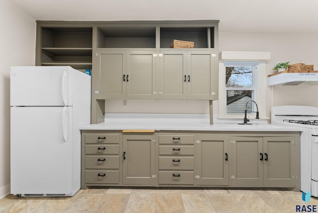 kitchen with white fridge, sink, gray cabinetry, and range