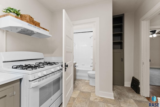 kitchen with white range with gas cooktop and ceiling fan