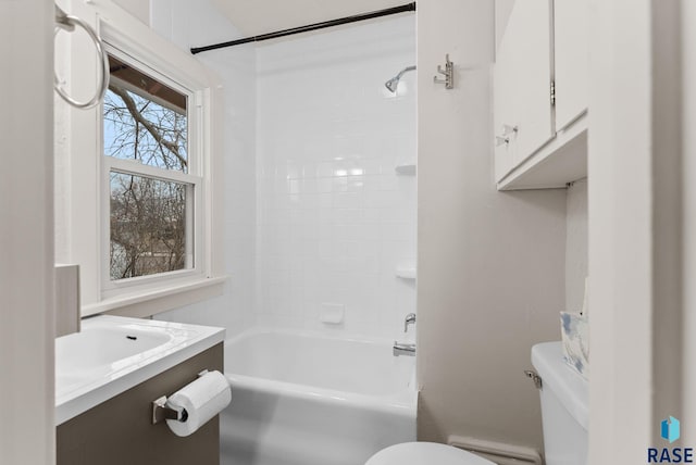 full bathroom featuring tiled shower / bath combo, vanity, and toilet