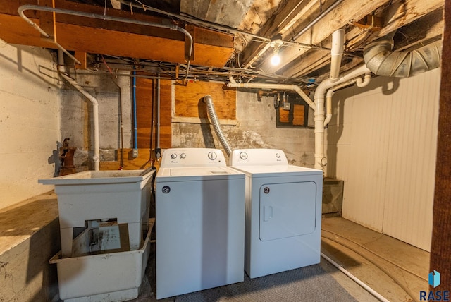 washroom featuring washer and dryer and sink