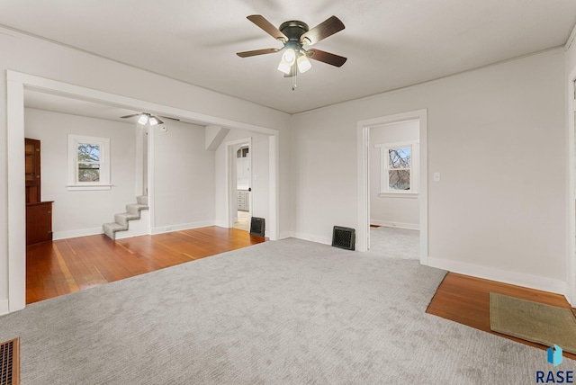 unfurnished living room with carpet flooring and ceiling fan