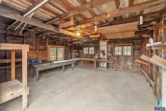 miscellaneous room featuring concrete flooring and a workshop area