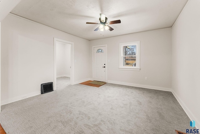 interior space featuring a textured ceiling, carpet floors, and ceiling fan