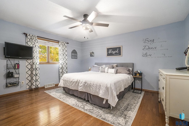 bedroom featuring dark hardwood / wood-style flooring and ceiling fan