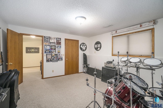 miscellaneous room featuring a textured ceiling and carpet flooring