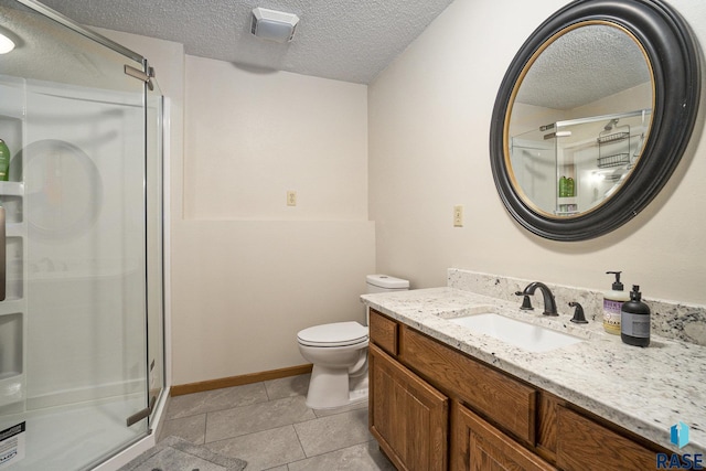 bathroom featuring a shower with door, tile patterned flooring, vanity, a textured ceiling, and toilet