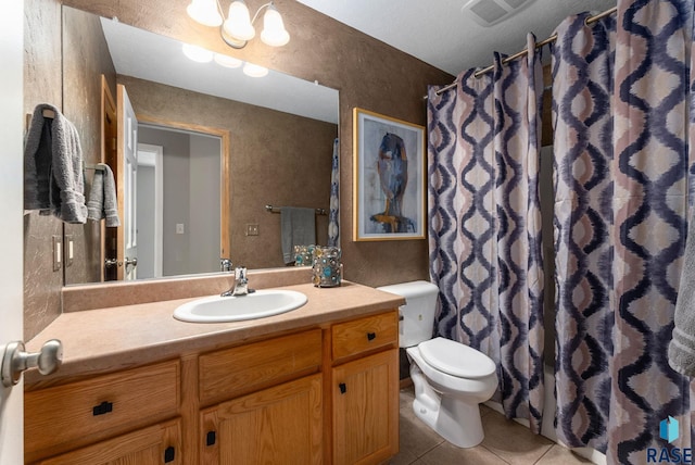 bathroom featuring tile patterned flooring, vanity, and toilet