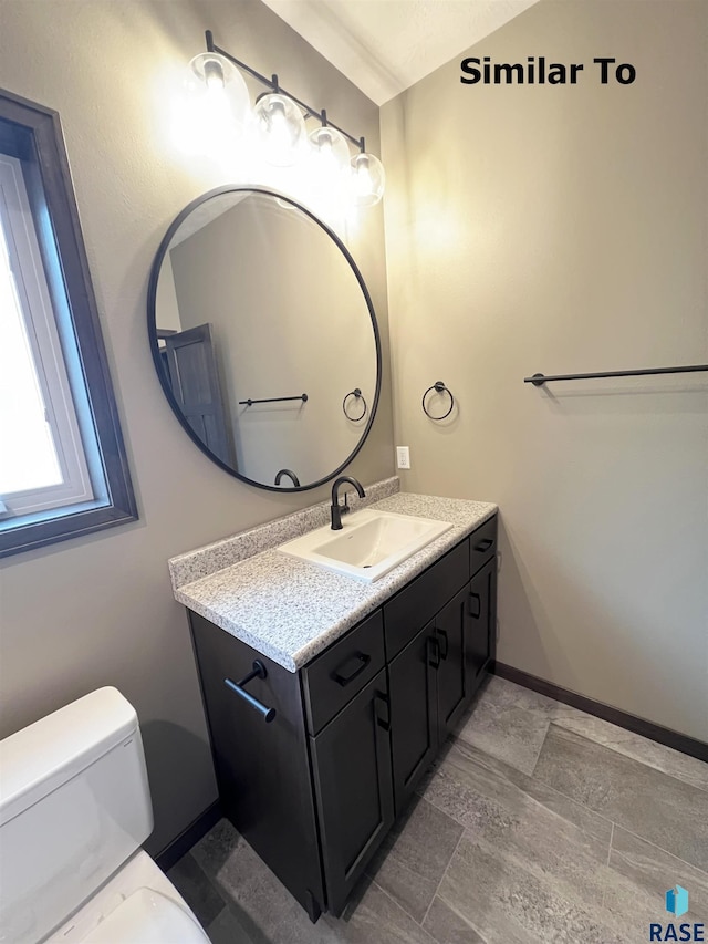 bathroom featuring vanity and toilet