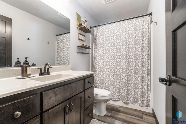 bathroom featuring vanity, hardwood / wood-style floors, and toilet