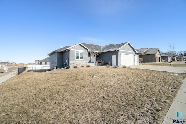 ranch-style house featuring a garage and a front lawn