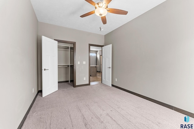 unfurnished bedroom featuring ceiling fan, light colored carpet, and a closet