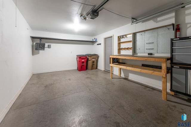 garage with a garage door opener and a workshop area