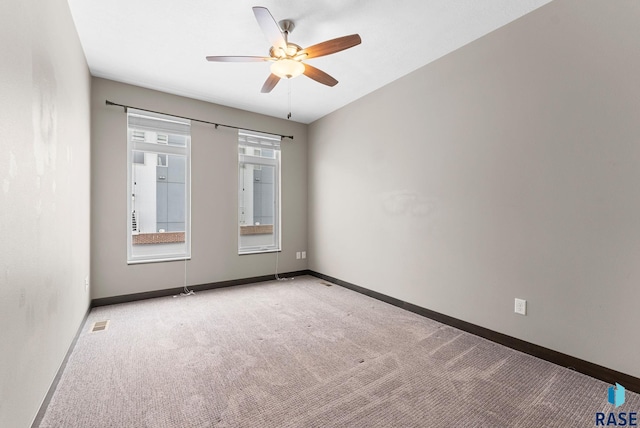 carpeted spare room featuring ceiling fan