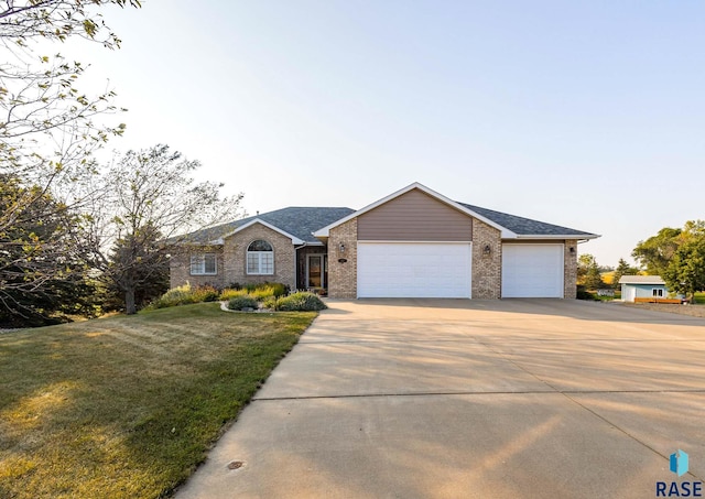 single story home with a garage and a front yard