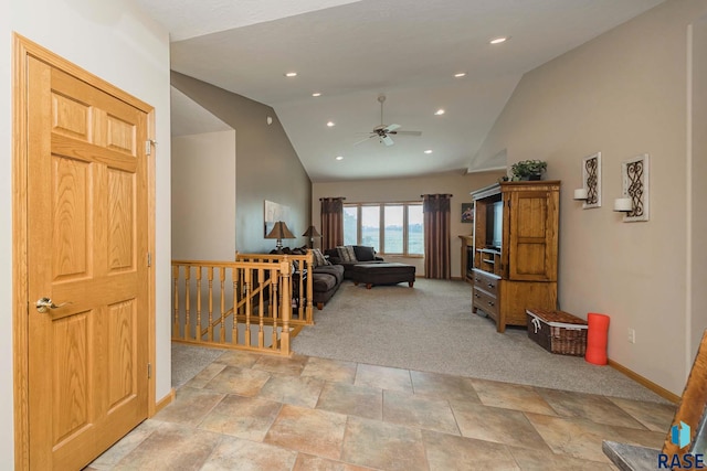 living room featuring lofted ceiling, light colored carpet, and ceiling fan