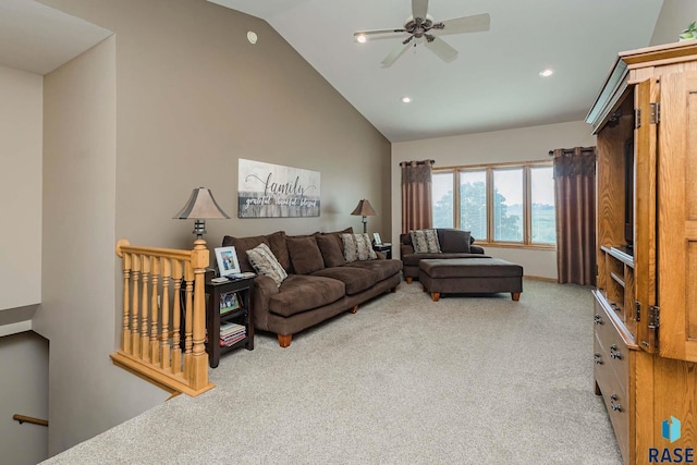 living room featuring high vaulted ceiling, light colored carpet, and ceiling fan