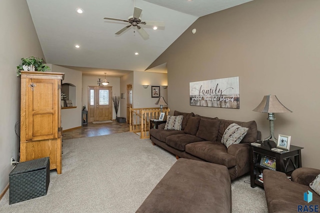 living room with ceiling fan, light colored carpet, and high vaulted ceiling