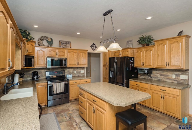 kitchen featuring sink, hanging light fixtures, tasteful backsplash, black appliances, and a kitchen island