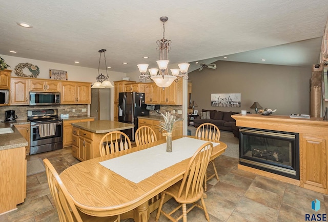 dining area with an inviting chandelier and a textured ceiling