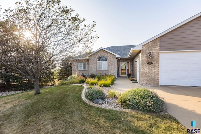 ranch-style home featuring a garage and a front yard