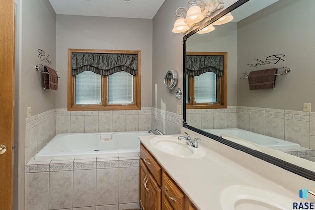 bathroom featuring vanity and tiled bath