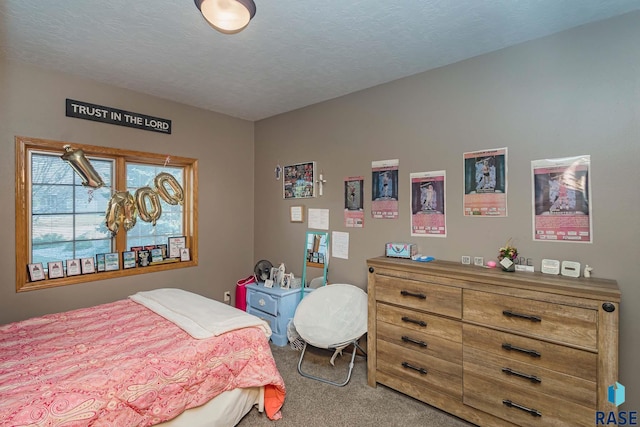 bedroom with carpet and a textured ceiling