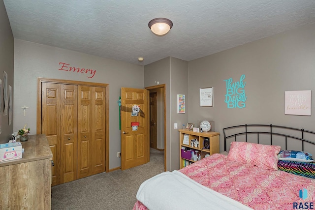 carpeted bedroom with a textured ceiling and a closet