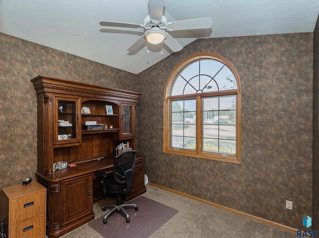 carpeted office with vaulted ceiling and ceiling fan