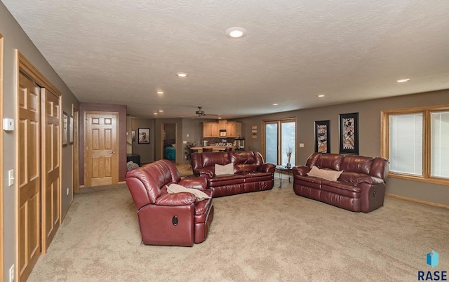 carpeted living room featuring a textured ceiling